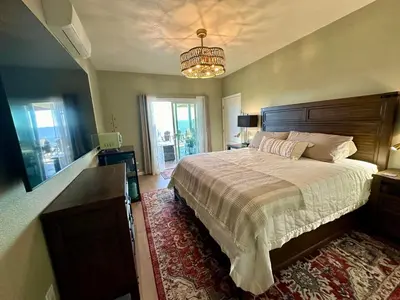 a bedroom with a large bed and a chandelier at Enchanted Property near Yosemite, View, Game Room in Ahwahnee