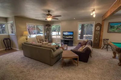 a living room with couches and a pool table at Corner Pocket Chalet home in South Lake Tahoe