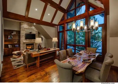 a dining room with a table and a fireplace at Penthouse Residence The Ritz-Carlton Lake Tahoe in Truckee