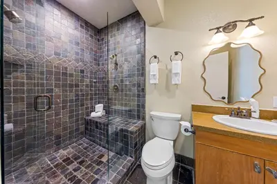 a bathroom with a toilet and a shower and a sink at Palisades Tahoe Lodge Rentals Premium Studio Loft #336 in Olympic Valley