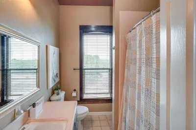a bathroom with a sink and a toilet and a window at Modesto Mansion on 2 Acres - Great for Families! in Modesto