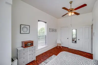 a white bedroom with a ceiling fan and a dresser at Modesto Mansion on 2 Acres - Great for Families! in Modesto