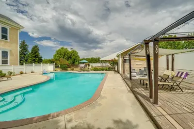 a swimming pool with a deck next to a house at Modesto Mansion on 2 Acres - Great for Families! in Modesto
