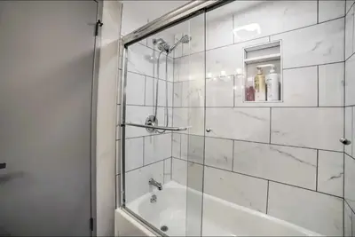 a bathroom with a shower and a tub and a sink at Tahoe Time Cabin in Incline Village