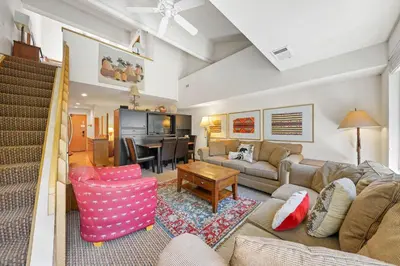a living room with a couch and a table at Palisades Tahoe Lodge Rentals Studio Loft #338 in Olympic Valley