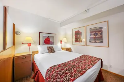 a hotel room with a large bed and two lamps at Palisades Tahoe Lodge Rentals Studio Loft #338 in Olympic Valley