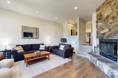 a living room with a couch and a fireplace at Above the Green in Groveland