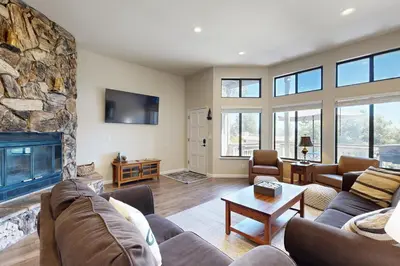 a living room with a couch and a fireplace at Above the Green in Groveland