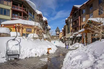 a street covered in snow next to buildings at Mountainback 35 in Mammoth Lakes
