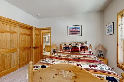 a bedroom with a large wooden bed in a room at Spacious Deck with Private Hot Tub Kings Beach Gem in Wood Vista