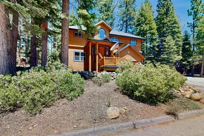 a wooden house in the woods with a yard at Spacious Deck with Private Hot Tub Kings Beach Gem in Wood Vista
