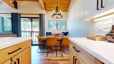 a kitchen and dining room with a table and chairs at Bigwood #45 condo in Mammoth Lakes