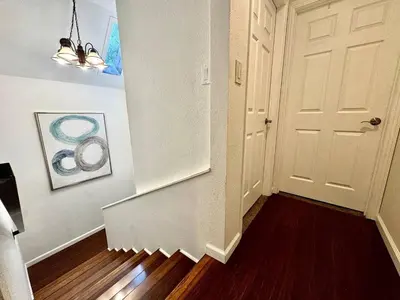 an empty hallway with a white door and a stair case at Cabin in the Trees-Game Room in Pollock Pines