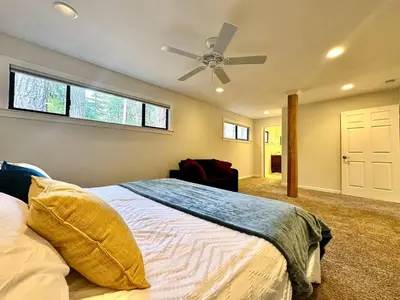 a bedroom with a bed and a ceiling fan at Cabin in the Trees-Game Room in Pollock Pines