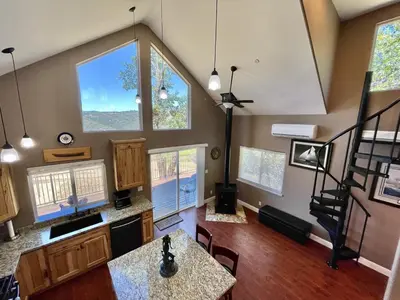 a living room with large windows and a staircase at Foothill Wine Country Gem in Somerset