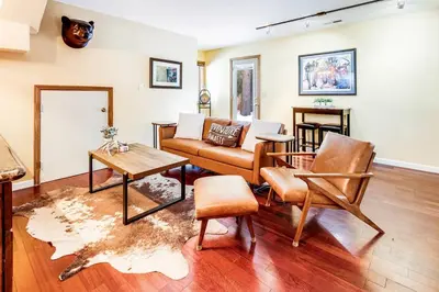 a living room with a couch and a table at Alpine Cottage Hideaway in Stateline