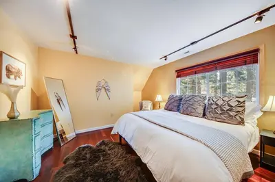 a bedroom with a large bed and a window at Alpine Cottage Hideaway in Stateline
