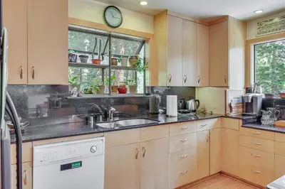 a kitchen with wooden cabinets and a sink at 1 Mi to Beach Peaceful Tahoe Vista Home with Decks! in Tahoe Vista