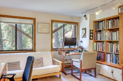 a living room with a couch and a desk with a computer at 1 Mi to Beach Peaceful Tahoe Vista Home with Decks! in Tahoe Vista
