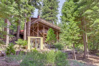 a log cabin in the woods with trees at 1 Mi to Beach Peaceful Tahoe Vista Home with Decks! in Tahoe Vista