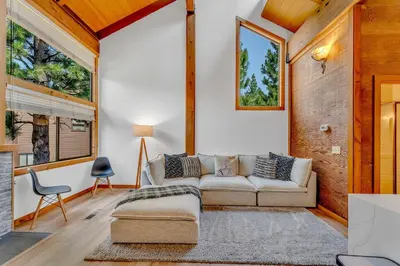 a living room with a couch and a chair at Bright 3BR Condo Near Northstar in Truckee