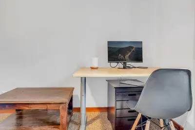 a desk with a computer monitor and a chair at Bright 3BR Condo Near Northstar in Truckee