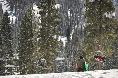 a group of people on a ski lift in the snow at Bright 3BR Condo Near Northstar in Truckee