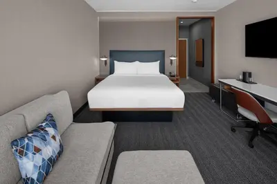 a hotel room with a bed and a couch at Courtyard by Marriott Reno Sparks in Clark