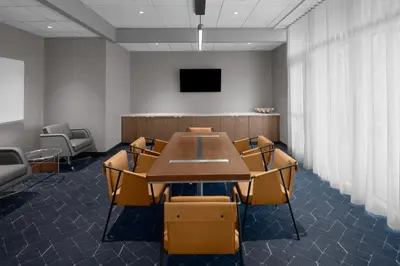 a conference room with a table and chairs and a tv at Courtyard by Marriott Reno Sparks in Clark