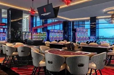 a casino with poker tables and chairs in a room at Chicken Ranch Casino Resort in Jamestown