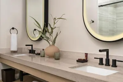 a bathroom with two sinks and a large mirror at Chicken Ranch Casino Resort in Jamestown
