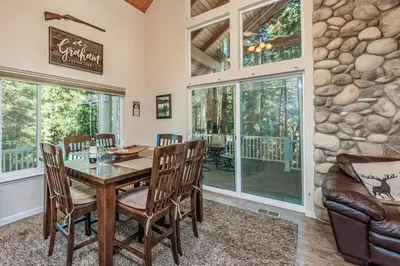 a dining room with a table and chairs at Cabin at the Creek Family Fun Starts Here! in Shaver Lake