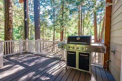 a grill on the deck of a cabin at Cabin at the Creek Family Fun Starts Here! in Shaver Lake