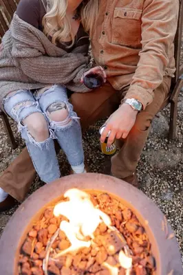 a man and woman sitting next to a pizza at Dogwood Peak Mid-Century A-Frame with AC Style in Shaver Lake