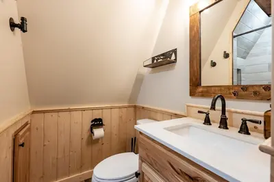 a bathroom with a sink and a toilet at HB Hideaway Boho Treehouse Vibes in the Pines in Shaver Lake