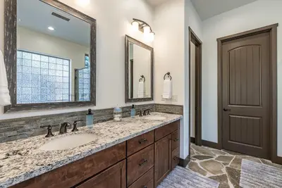 a bathroom with a sink and a mirror at Leopard Lily Lodge Luxe Stays 2 Suites AC in Shaver Lake
