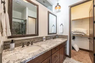 a bathroom with a sink and two mirrors at Leopard Lily Lodge Luxe Stays 2 Suites AC in Shaver Lake