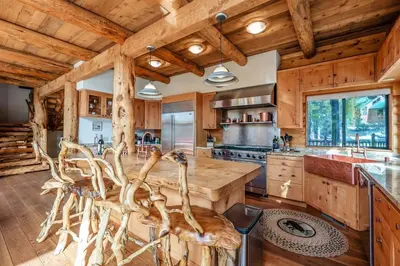 a kitchen with wooden ceilings and a large wooden table at Waterfall Lodge Yellowstone Vibes AC Space in Shaver Lake