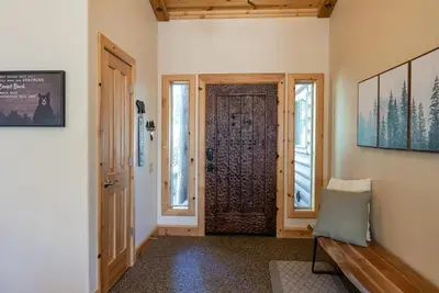 a hallway with a door and a bench in a room at The Restful Rose Fireside Vibes AC Comfort in Shaver Lake