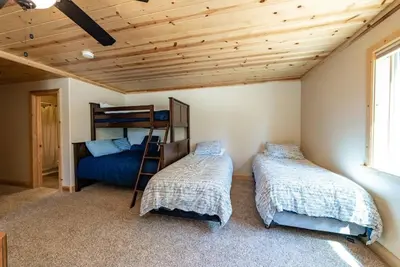 a bedroom with two beds and a bunk bed at The Restful Rose Fireside Vibes AC Comfort in Shaver Lake
