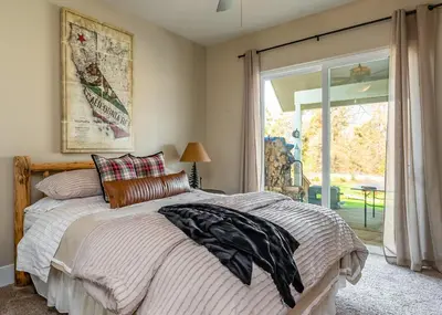 a bedroom with a bed and a sliding glass door at The Great Escape Sunsets Hot Tub Bliss in Shaver Lake