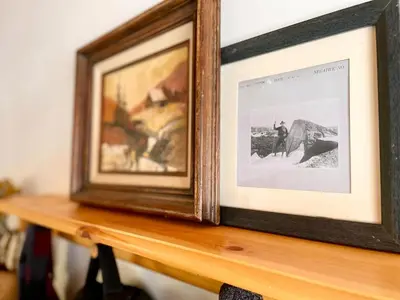 a picture frame sitting on top of a wooden table at The Cedar House Prime Spot Kayaks & Cool AC in Shaver Lake