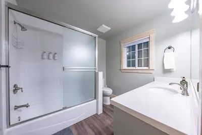 a white bathroom with a shower and a sink at The Sparrows Nest Cozy Charm Fire Pit Fun in Shaver Lake