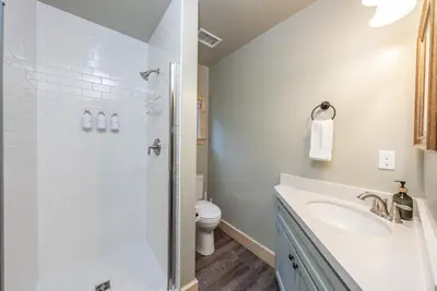 a white bathroom with a sink and a toilet at The Sparrows Nest Cozy Charm Fire Pit Fun in Shaver Lake