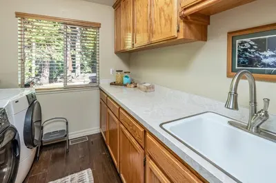 a kitchen with a sink and a dishwasher at Shady Pines Smores, Stars & Cozy Nights In in Shaver Lake