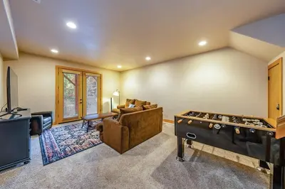 a living room with a couch and a pool table at Sierra Pines Villa Deck Jetted Tub Game Rm in Shaver Lake