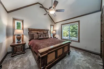 a bedroom with a bed and a ceiling fan at Lux Western Cabin Pool Table Ping Pong Vibes in Shaver Lake