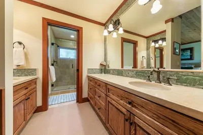 a bathroom with a sink and a mirror at Chambers Lakeside Escape w Lake Views & HOA Access! in Homewood