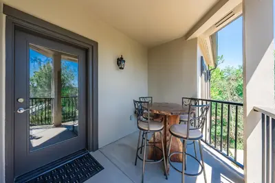 a balcony with a wooden table and chairs at The Chalet at Shaver Lake We Have it ALL! in Shaver Lake