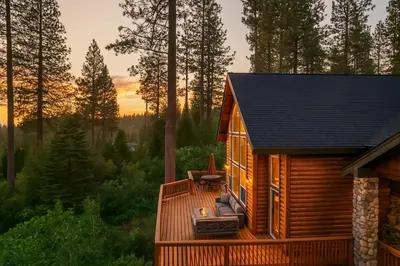 a cabin in the woods with a deck at Sunset Mountain Hot Tub, Fire Table, Epic Views in Shaver Lake